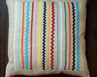 Decorative cushion made from hand woven hemp with colourful  ric rac decoration