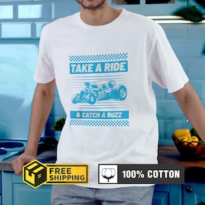 May include: White t-shirt with a blue graphic of a hot rod and the text "TAKE A RIDE & CATCH A BUZZ". The shirt is made of 100% cotton.