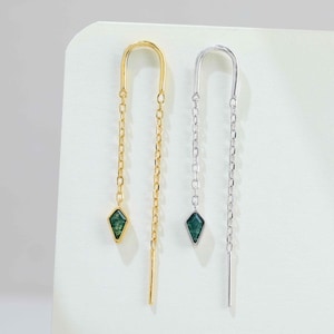 May include: Two pull-through threader earrings, one in gold-tone metal and one in silver-tone metal. Each earring features a delicate chain with a small, kite-shaped green stone pendant at one end and a straight metal post at the other end.