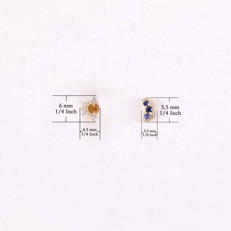 May include: A pair of gold earrings with a sun and moon design. The sun earring features a yellow gemstone surrounded by clear cubic zirconia stones. The moon earring features three blue sapphires. The earrings measure 6 mm (1/4 inch) and 5.5 mm (1/4 inch) in diameter.