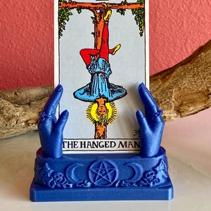 May include: A set of three ceramic mugs with a speckled, matte finish. The mugs are in shades of cream, light gray, and dark gray. Each mug has a simple, minimalist design, perfect for coffee or tea.