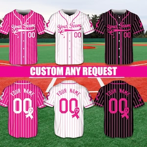 May include: Baseball jerseys in pink, white, and black with vertical stripes. Each jersey features the text "Your Team" or "Your Name" with the number "00" and a pink ribbon. The image also includes the text "CUSTOM ANY REQUEST".