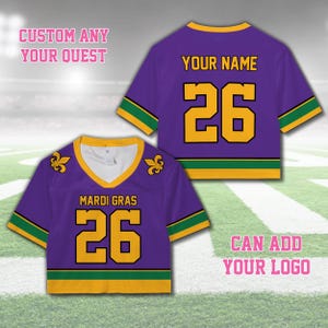 Pode incluir: Duas camisas roxas do Mardi Gras com detalhes dourados e verdes. Uma camisa tem o texto "MARDI GRAS" e o n&uacute;mero "26". A outra camisa tem o texto "YOUR NAME" e o n&uacute;mero "26". A imagem tamb&eacute;m inclui o texto "CUSTOM ANY YOUR QUEST" e "CAN ADD YOUR LOGO".