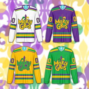 May include: Four long-sleeved Mardi Gras jerseys in white, purple, yellow, and green. Each jersey has the text "Mardi Gras" in a stylized font, the number "0", and purple, green, and yellow stripes.