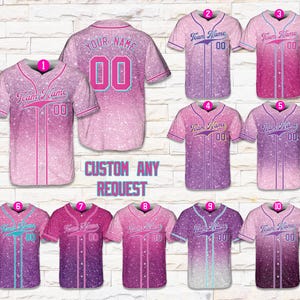 May include: A collection of baseball jerseys in various shades of pink and purple, with a glittery effect. Each jersey features the text "Team Name" and the number "00". The text "CUSTOM ANY REQUEST" is also visible.