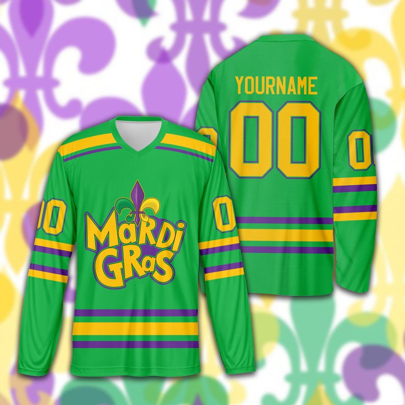 May include: Green long-sleeved jersey with gold and purple accents. The front features the words "Mardi Gras" in yellow with a purple fleur-de-lis. The back has the word "YOURNAME" above the number "00" in gold. The sleeves have the number "0" and "10".