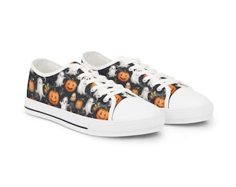 May include: A pair of white-soled canvas sneakers with a Halloween-themed pattern. The pattern features orange jack-o'-lanterns and white ghosts on a black background. The sneakers have white laces and a white toe cap.