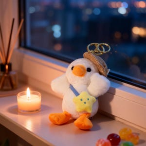 Llavero de pato de peluche: bonito pato blanco con sombrero y bolsa de estrella. Suave llavero de viaje para bolsos y regalos, decoración kawaii.