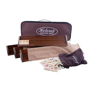 May include: A wooden Rummikub game set with a brown carrying case, a brown wooden rack, and a bag of tiles. The tiles are white with black numbers and colored dots. The carrying case has the text "Helena WOOD ART" on it.