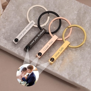 May include: Four silver, black, rose gold, and gold keychains with engraved messages: "Love you mummy", "Love you forever", "I Love You", and "Drive Safe". Each keychain features a small black stone.