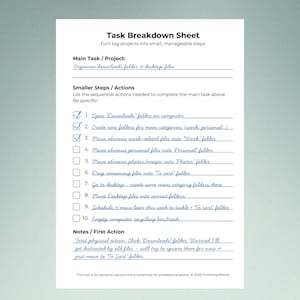 Filled-in Task Breakdown Sheet shown flat against a muted sage green background with soft shadow. Title "Task Breakdown Sheet" at top. Main task in blue handwriting reads "Organize downloads folder + desktop files." Ten numbered steps are written in blue cursive with checkboxes, three checked off. Notes section includes a handwritten reflection about the first action. Clean white worksheet with grey-green checkbox outlines. Footer has personal use disclaimer and © 2025 ForPrintsOfMind.