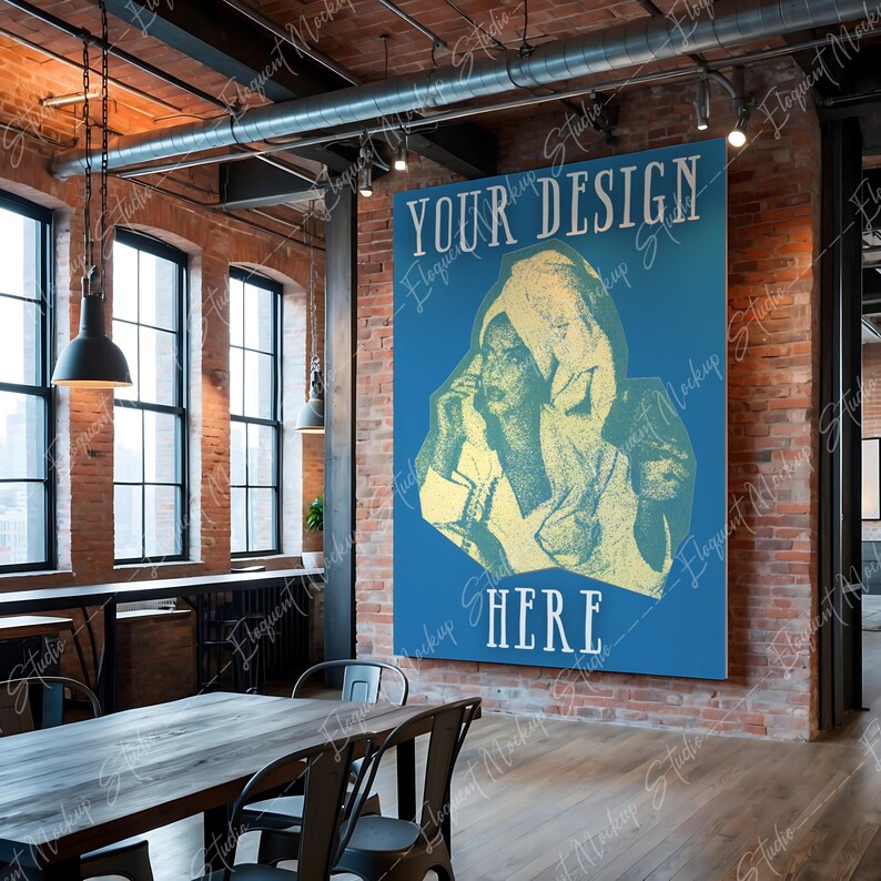 Op de afbeelding: Een blauwe poster met de tekst "YOUR DESIGN HERE" in wit. De poster toont een vintage-illustratie van een vrouw die een gewaad met capuchon draagt. De poster hangt aan een bakstenen muur in een loft-achtige ruimte.