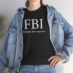 May include: A black t-shirt with white text that reads "FBI" and "Formable Beer Inspector".