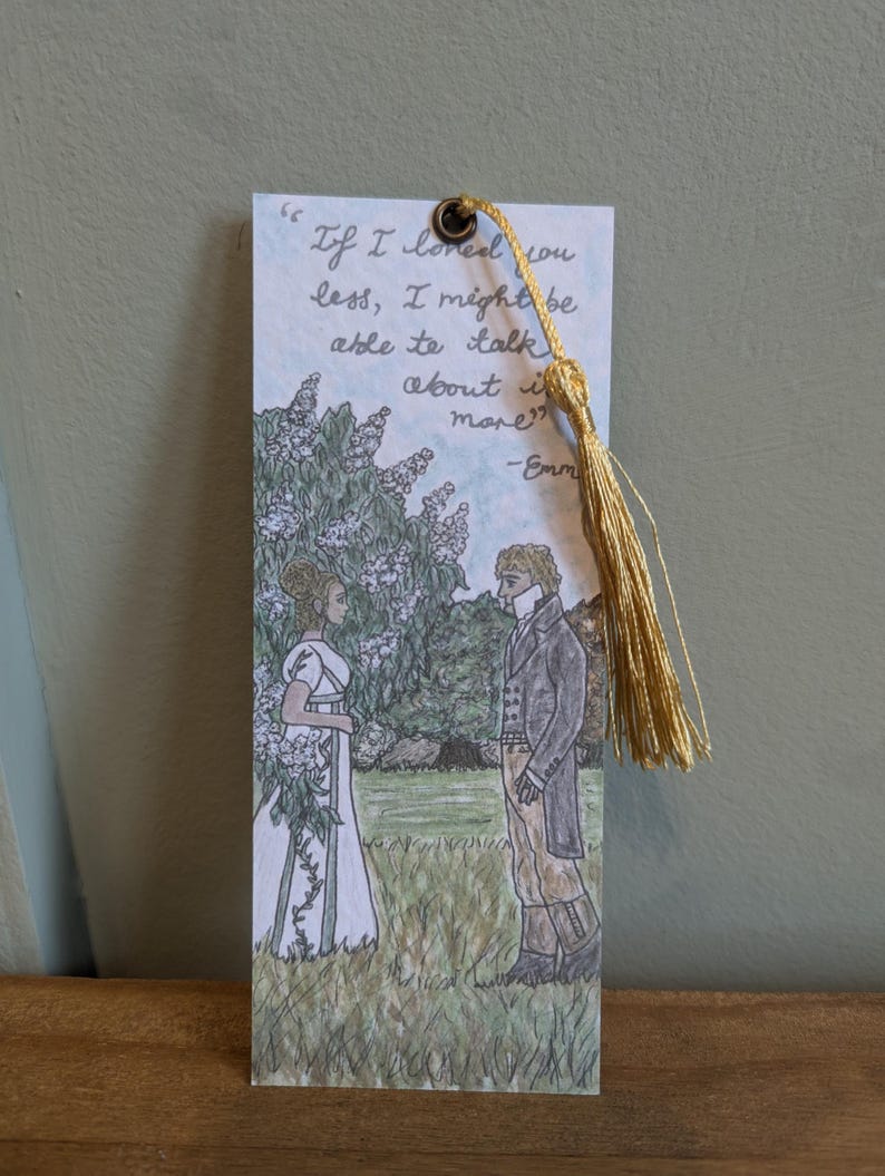 May include: A bookmark with a hand-drawn illustration of a couple standing in a garden. The bookmark features a quote from the novel "Emma" by Jane Austen: "If I loved you less, I might be able to talk about it more." -Emma