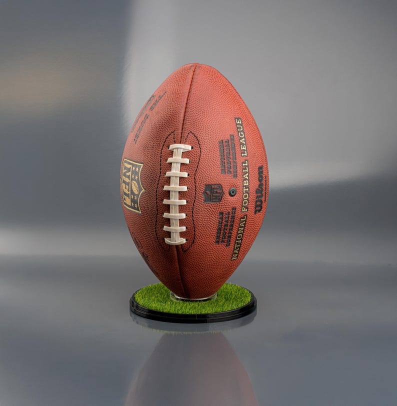 NFL football display stand with a sturdy black base, designed to hold and showcase a full-size American football vertically or horizontally, ideal for sports memorabilia display.