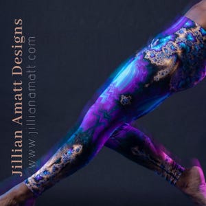 May include: Vibrant leggings with a swirling, abstract design in shades of purple, blue, and gold. The leggings feature a unique pattern and the text "Jillian Amatt Designs" and website address.