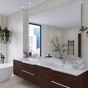 May include: A modern bathroom with a white bathtub, double vanity sink with a dark wood cabinet, and a large mirror reflecting a city view. The bathroom features a hanging plant and a towel rack.