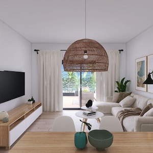 May include: A living room interior with a white sofa, a wooden coffee table, and a wicker pendant light hanging from the ceiling. The room has white walls and large windows with white curtains. There are two green bowls on the coffee table.