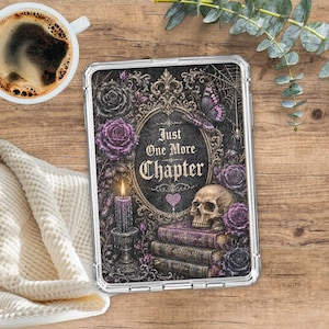 May include: A clear tablet case featuring a gothic design with the text Just One More Chapter, a human skull, stacked books, purple roses, a lit candle, a butterfly, and a spiderweb, all framed within an ornate gold-colored oval border.