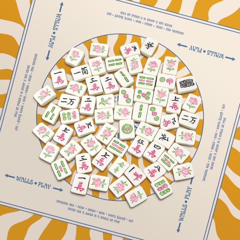 May include: A set of white Mahjong tiles with black Chinese characters and pink rose illustrations, arranged on a cream-colored game board with text that reads "WALLS &bull; PLAY". The board has a yellow and white striped background.