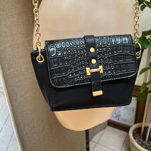This is a metallic brown leather shoulder bag with a textured finish