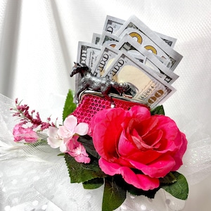 Alimony Pony - Adorable Kentucky Derby Fascinator - Pink flowers on a  White base headband, w/ Hot pink purse stuffed with money. So cute!