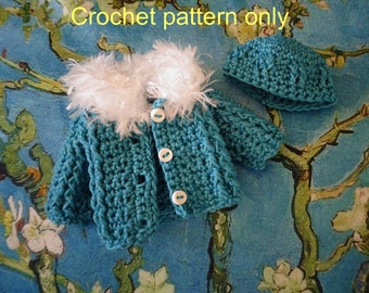 May include: A teal blue crocheted baby jacket with a white faux fur trim around the collar. The jacket has three white buttons down the front. A matching teal blue crocheted hat is also included.