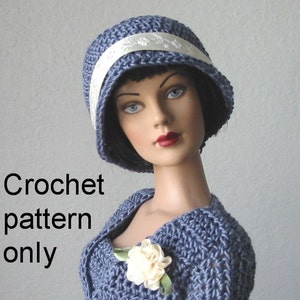 May include: A crochet pattern for a blue cloche hat with a white ribbon. The pattern is for a doll or small child.