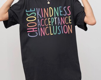 May include: Black t-shirt featuring the words "CHOOSE KINDNESS ACCEPTANCE INCLUSION" in pastel colours. The shirt has a loose fit and short sleeves, suitable for everyday wear.