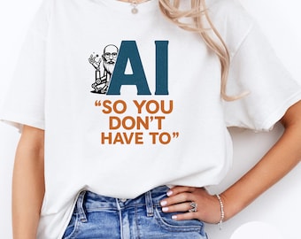 May include: White t-shirt with a graphic design featuring the letters "AI" in dark teal, a cartoon image of a man with glasses and a beard, and the text "SO YOU DON'T HAVE TO" in orange.