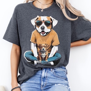 Cartoon Dog Holding Real Puppy T-Shirt – Funny Unisex Dog Lover Tee | Cool Pup in Sneakers +Shades | Cute & Wholesome Graphic Shirt