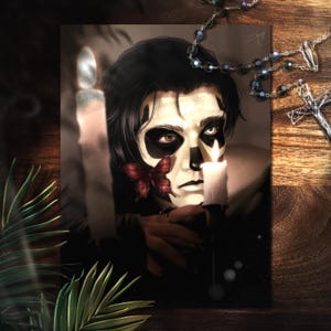 May include: An artistic portrait of a person with black hair and a skull-like face, holding a lit candle. A red butterfly is near the face. A rosary and cross are visible. The image has a dark, gothic theme.