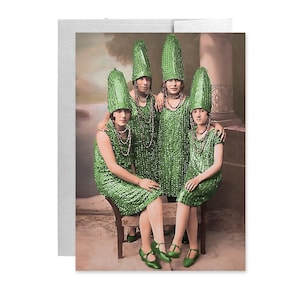 May include: A vintage-style greeting card featuring a group of four women in matching green sequined dresses and tall, pointed hats. They are posed in front of a faded, classical backdrop, with each wearing a beaded necklace and green shoes.