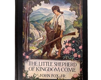 May include: The cover of a book titled "The Little Shepherd of Kingdom Come" by John Fox, Jr. The cover features an illustration of a young boy with a rifle and a dog in a forest setting.