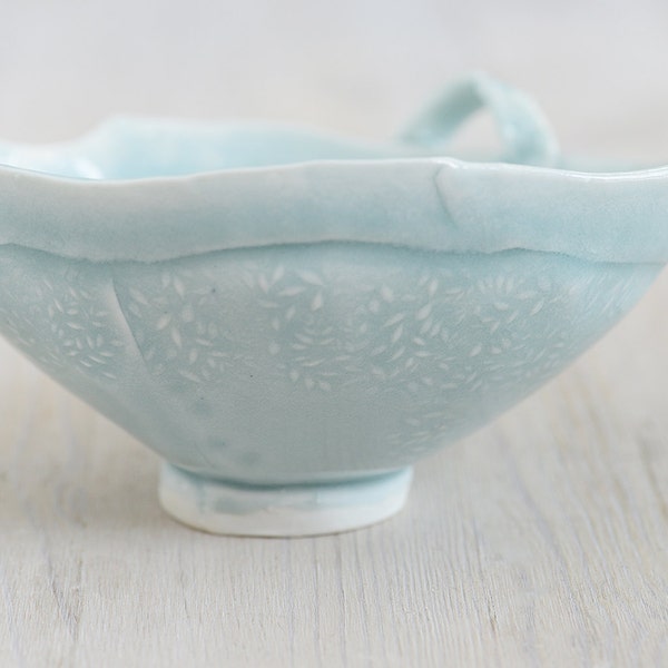Hand built porcelain delicate bowl with light blue glaze