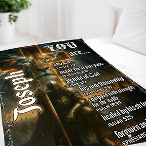 May include: A blanket with a lion's head, a knight, and the name "Joseph." The blanket includes the text "YOU are..." and various Bible verses. The design incorporates a cross and lightning bolts.