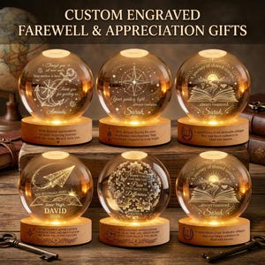 May include: Custom engraved farewell and appreciation gifts. The image shows six illuminated glass globes with personalized messages and designs, including an anchor, compass, and open book. Each globe sits on a wooden base, making them ideal for gifting.