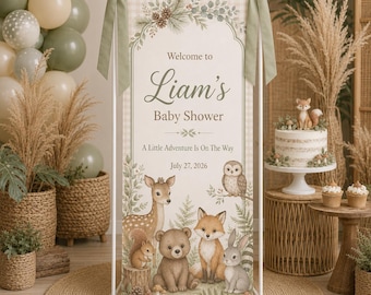 May include: A vertical rectangular banner for a baby shower featuring the text Welcome to Liam's Baby Shower, A Little Adventure Is On The Way, and July 27, 2026. The banner displays illustrations of a deer, bear, fox, rabbit, owl, and squirrel.