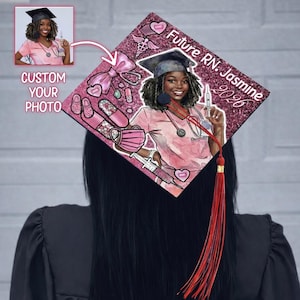 May include: A custom graduation cap with a pink glitter background, featuring a portrait of a woman in nursing scrubs. The cap includes medical-themed illustrations and the text "Future RN. Jasmine 2020". A red tassel hangs from the cap.