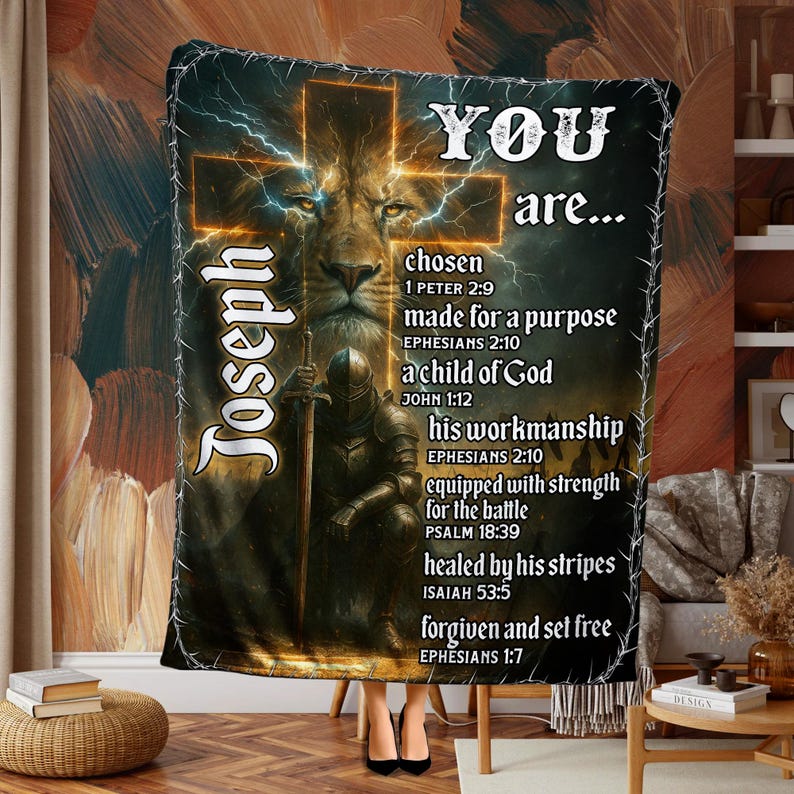 May include: A brown and gold blanket with a lion's face, a knight, and the text "YOU are..." with religious verses. The design includes a cross and lightning bolts. The name "Joseph" is also displayed on the blanket.