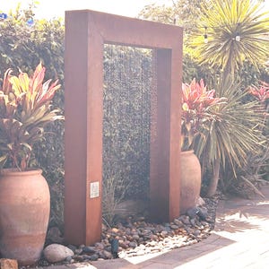 “Door style rain curtain fountain in corten steel — modern outdoor water feature, backyard garden decor, patio fountain for relaxation” “Corten steel rain curtain water feature — peaceful outdoor fountain for backyard, patio, or garden — creates calming waterfall sound” “Luxury corten steel rain curtain fountain — modern door design outdoor water feature for upscale backyard, pool, or garden oasis”