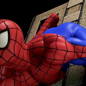 May include: A red and blue action figure of Spider-Man in a dynamic pose, climbing a brick wall. The figure is highly detailed, with a textured suit and a classic Spider-Man mask.