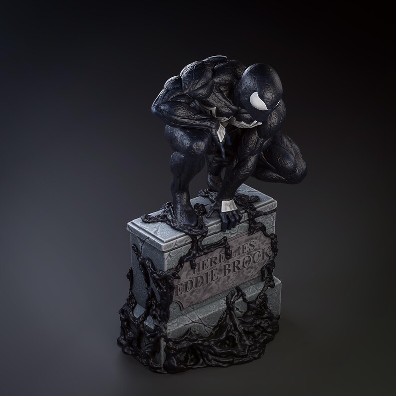 May include: Black and white figurine of Venom, a Marvel Comics character, perched on a tombstone. The tombstone reads "Here Lies Eddie Brock".
