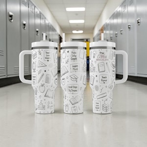 May include: Three white Stanley tumblers with black line art of school-related icons and text. Each tumbler has a white handle and lid with a straw. The text includes "Teach Love Inspire", "Make Today Count", and "Teach Repeat".
