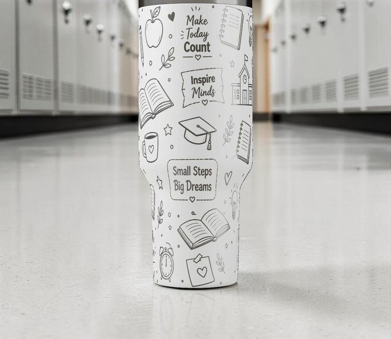 May include: White tumbler with black line art illustrations and text. The design includes an apple, books, a coffee cup, a graduation cap, and the phrases "Make Today Count," "Inspire Minds," and "Small Steps Big Dreams."