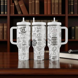 May include: Three white insulated tumblers with handles and straws, each adorned with black line art and text related to law. The text includes phrases like "I PUT THE LIT IN LITIGATE" and "WHERE THERE'S A WILL THERE'S A LAWYER."