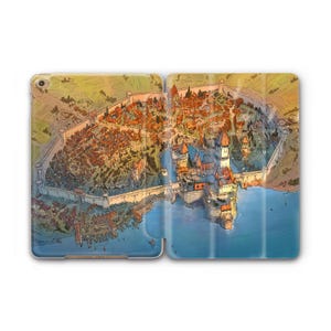 May include: A tablet case featuring a detailed illustration of a medieval city with a river and castle. The artwork includes buildings, walls, and a harbor, rendered in warm tones of orange, brown, and blue.