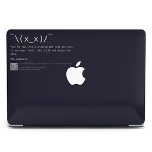 May include: A dark blue laptop with a white Apple logo and humorous text. The text reads "Your PC ran into a problem but lets be real, it was your fault. Get a ISO and enjoy the wiki. 69% complete."