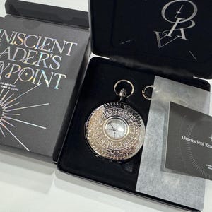 May include: A black box with the text "Omniscient Reader's Viewpoint" on the lid. The box contains a silver pocket watch with an intricate design and a black and white card with the same text as the box.