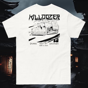 May include: White t-shirt with a black graphic of a bulldozer with the text "BULLDOZER" in Japanese characters and "Gramby Bulldozer Colorado June 4, 2004" underneath.